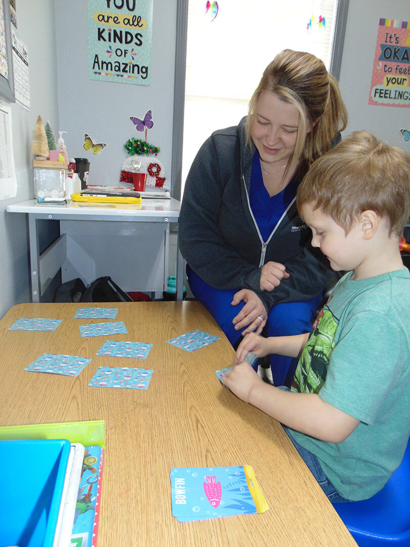 Kid doing Autism testing with staff