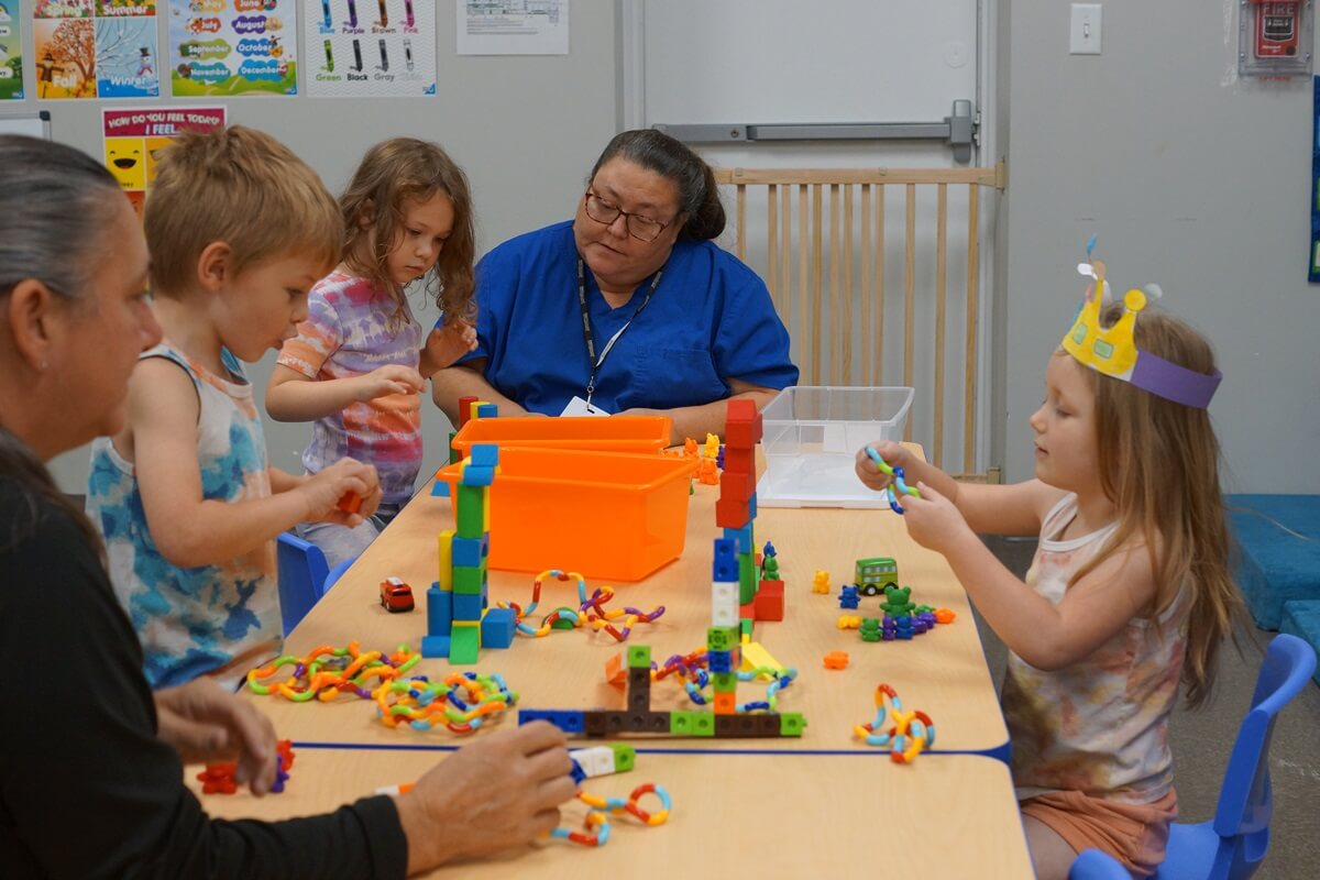 kids playing with toys at a table